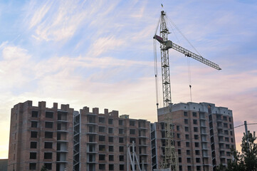 construction crane. against the background of a house under construction