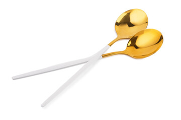 Golden spoons on white background