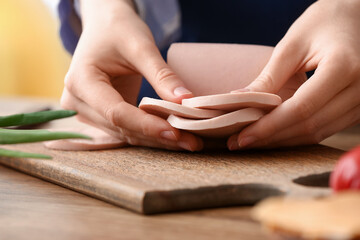 Woman holding boiled sausage at table in kitchen © Pixel-Shot