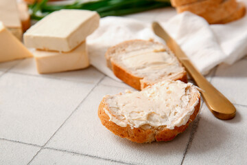 Sandwiches with processed cheese and herbs on white tile background