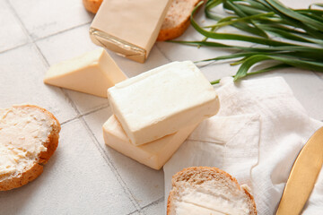 Sandwiches with processed cheese and herbs on white tile background