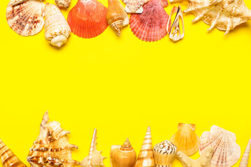 Frame made of seashells and starfishes on yellow background