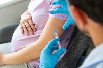A pregnant woman makes a vaccination. Selective focus.