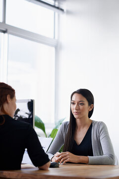 Documents, job interview and business women in office for conversation, talking and discussion at desk. Meeting, partnership and female workers with paperwork for consulting, hiring and recruitment