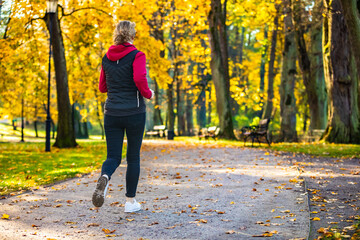 Healthy lifestyle - woman running in city park
