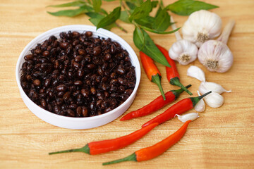 Fried insects, Subterranean ants or Carebara castanea Smith  on white plate. Red chillies, garlics  herbal vegetables. Concept,  food ingredient. Edible insects, Weird food.            