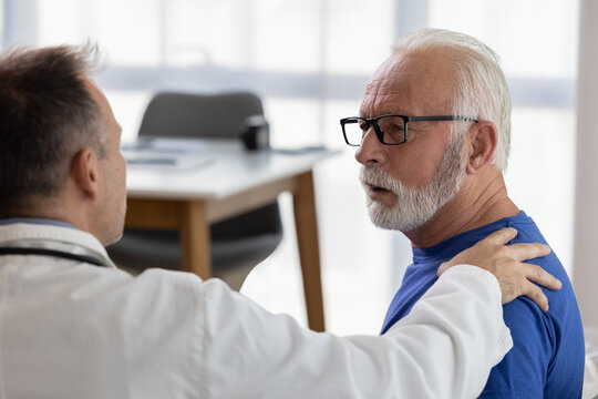 Doctor Comforting And Supporting Sad Senior Patient Having Bad Diagnosis, Disease Or Health Problem. Empathy Consoling Concept At Medical Consultation