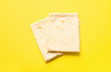 Fresh thin lavash on yellow background