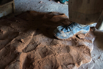 Close up hands of the traditional pottery making in the old way clay and Kneading and mashing the mud with hands and feet
