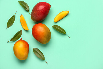 Fresh ripe mangoes on turquoise background