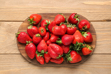 Board of fresh strawberries on wooden background