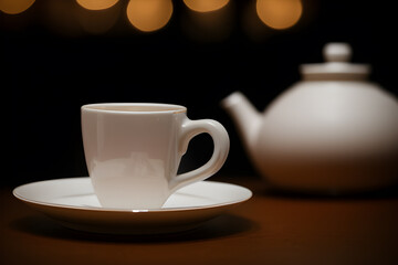 Obraz na płótnie Canvas Cup of tea and teapot on table. Generative ai