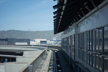 A curving railway pulls up to an enclosed train station.