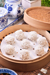 Glutinous rice meatballs in the bamboo steamer 