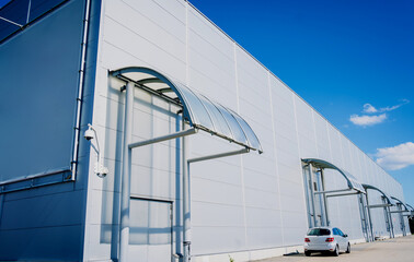 Modern big industrial warehouse buildings at the blue sky background.