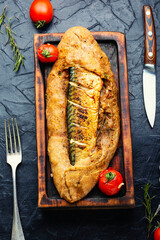Whole fish baked in bread, fish pie.