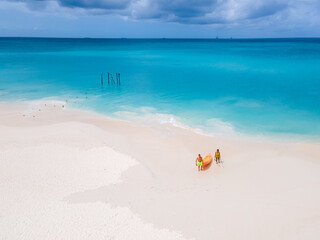 Fototapeta na wymiar Couple Kayaking in the Ocean on Vacation Aruba Caribbean Sea