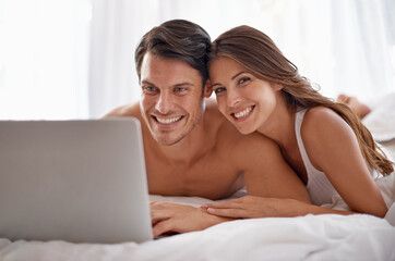 Love portrait, laptop and bedroom couple relax for morning peace, calm and streaming online Valentines Day movie. Smile, vacation holiday and romantic people bonding on hotel bed in Toronto Canada