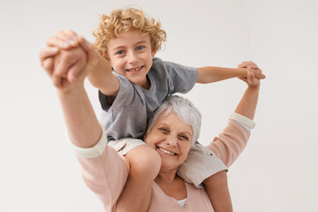 Airplane, portrait and grandmother with child embrace, happy and bonding against wall background. Love, face and senior woman with grandchild having fun playing, piggyback and enjoying game together