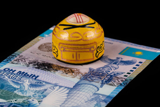 A symbolic wooden yurt, a traditional dwelling of nomads, on the fln of a fragment of a banknote in denominations of 10,000 Kazakhstani tenge