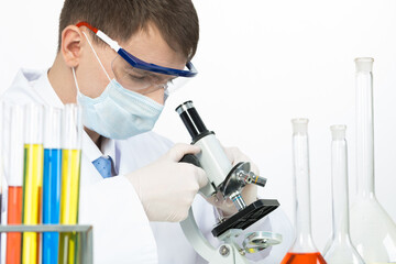 Scientist looking through microscope in laboratory