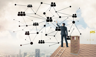 Businessman on house roof presenting networking and connection c