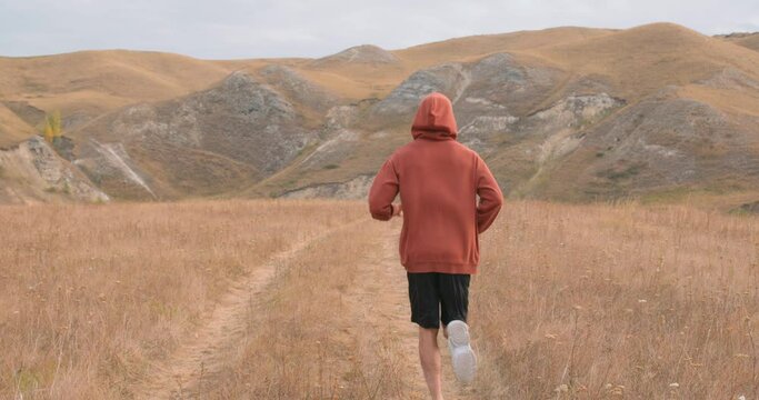 cross-country running. athlete runs on mountains. Training triathlon athlete on trail run outdoor exercise endurance workout. willpower daily routine, healthy lifestyle, good habit