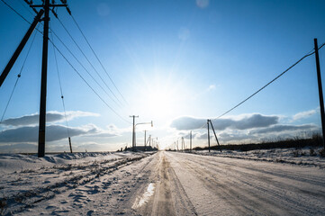 北海道野付半島の一本道、青空と太陽と電柱