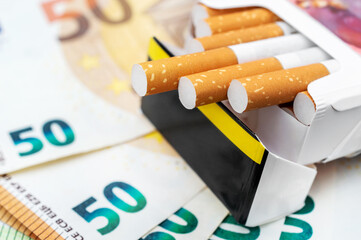 Pack of cigarettes on the euro bills. Close up.