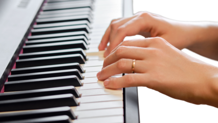 An adult woman plays an electric piano, hands close-up, isolated on white background. Female hands on the keys of a portable electronic piano