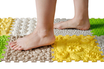 Woman foots close-up on a medical orthopedic mat, isolated on white background. Female legs with...