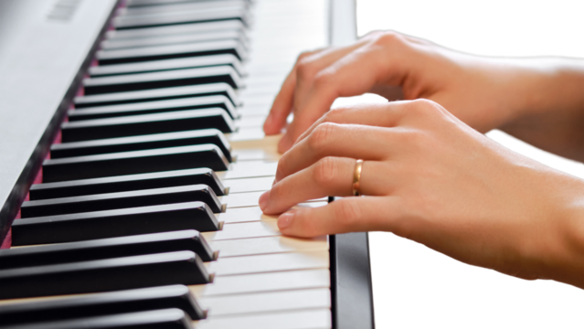 An adult woman plays an electric piano, hands close-up, isolated on white background. Female hands on the keys of a portable electronic piano