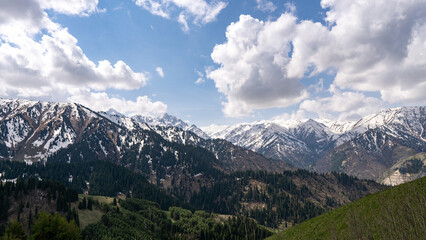 clouds over snowy mountain peaks. cloudy weather in the mountains