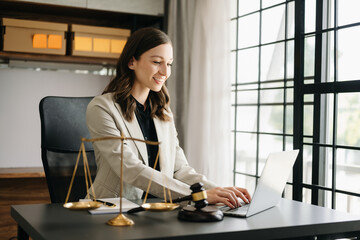 Beautiful Caucasian woman lawyer working and gavel, tablet, laptop in front, Advice justice and law...