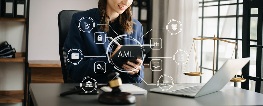 AML Anti Money Laundering Financial Bank Business Concept. judge in a courtroom using laptop and tablet with AML anti money laundering icon on virtual