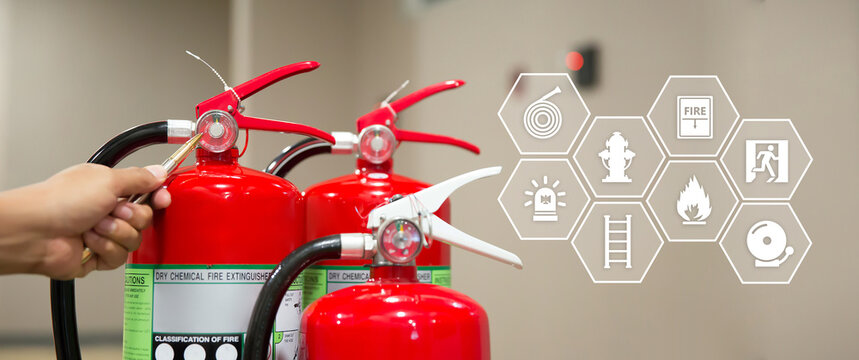 Fire extinguisher has hand engineer checking pressure gauges and prevent icons to prepare fire equipment for protection in emergency case and safety or rescue and alarm system training concept.