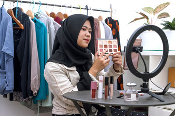Muslim asian female beauty social media influencer livestream marketing cosmetics a make up...