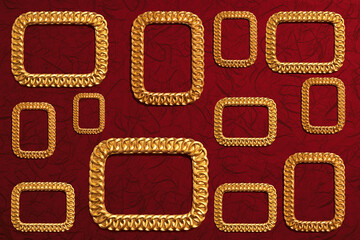 Ornate gold picture frames at dark red grunge wallpaper.
