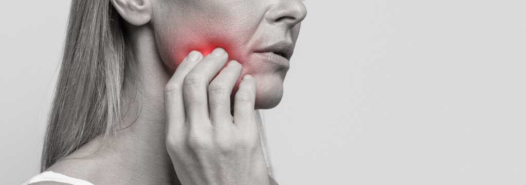 Cropped of woman suffering from strong tooth pain, closeup