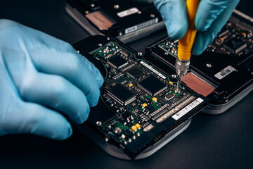 Computer service engineer technician workplace repairing fixing disassembled HDD hard drive data disc SSD, backup part of PC or laptop. Recovery, maintenance work, access file. Profession repairman

