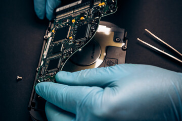 Computer service engineer technician workplace repairing fixing disassembled HDD hard drive data...