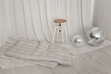 Round high chair with mattress and disco ball on the floor in photostudio

