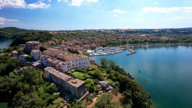 Scenic lakes of Italy - beautiful Lago di Bolsena. aerial dron video of Capodimonte medieval village. Viterbo province, Lazio region