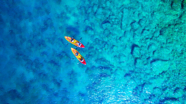 Kayaking. Aerial view of floating kayaks and people on blue sea at sunny day. Travel and active life image. Summertime vacation. Mediterranean sea.