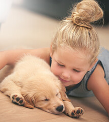 Girl child hug her puppy, relax at home and happy with sleeping golden retriever dog, friends and peace. Pet care, love and young, calm female kid with her domestic animal lying on wood floor