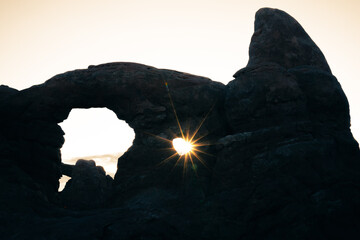 silhouette of turret arch at the sunrise in arches national park © DEN