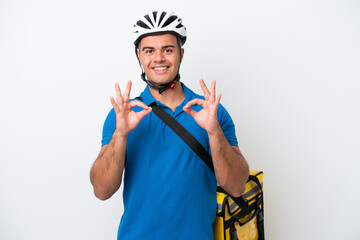 Young caucasian man with thermal backpack isolated on white background showing an ok sign with fingers