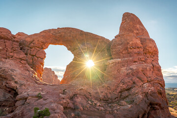 sun shining through turret arch at arches national park in utah usa © DEN