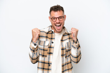 Naklejka premium Young caucasian handsome man isolated on white background celebrating a victory in winner position