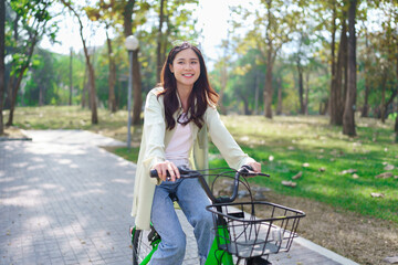 Women riding bicycle with having fun to exercise activity with healthy lifestyle in the park
